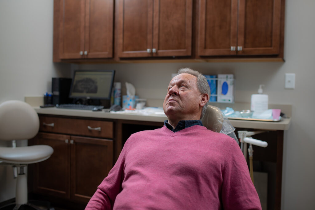 A patient listening to his oral surgery and post-op options at Associated Oral & Implant Surgeons