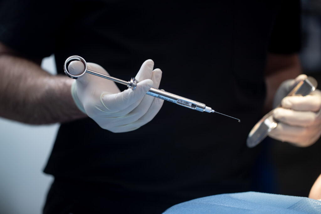 surgeon preparing to sedate a patient before oral surgery at Associated Oral & Implant Surgeons