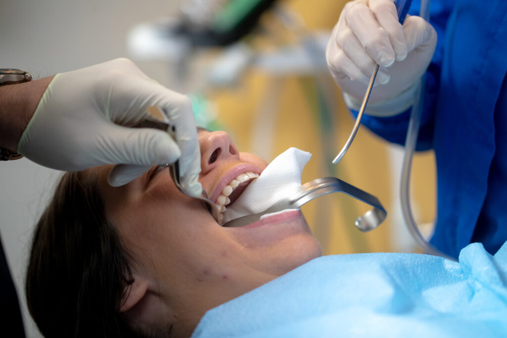 patient undergoing emergency dental care for a tooth extraction at Associated Oral & Implant Surgeons