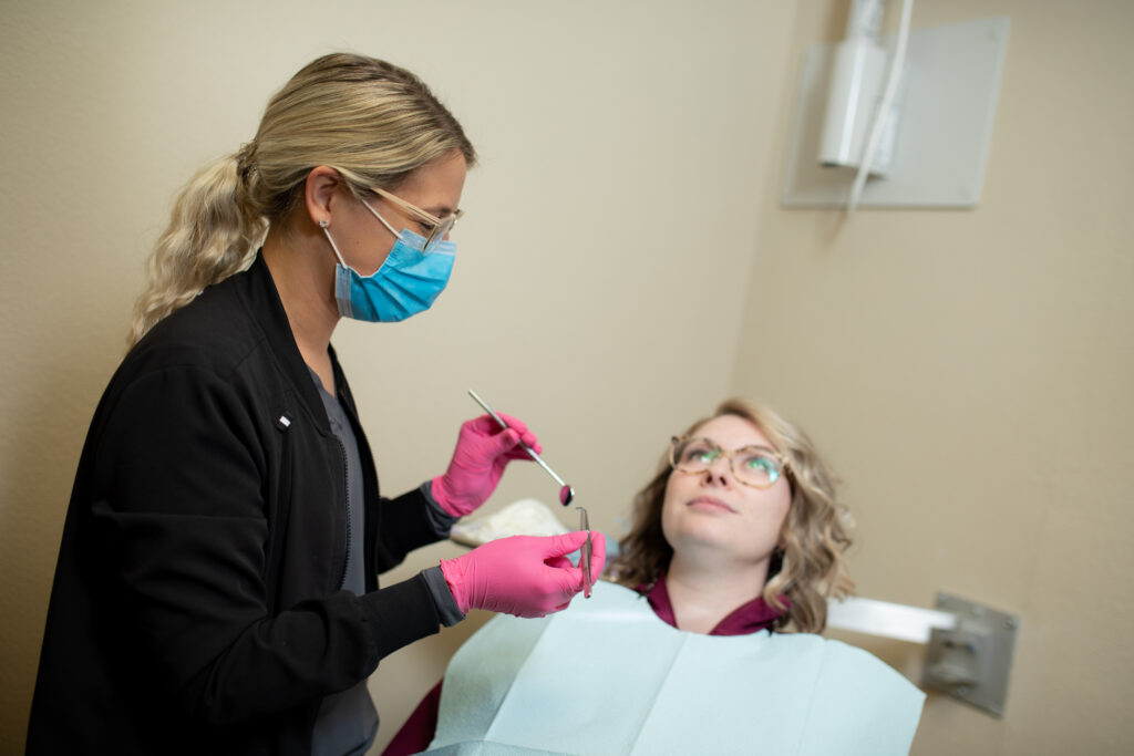 referral patient in a dental chair receiving dental care at Associated Oral and Implant Surgeons