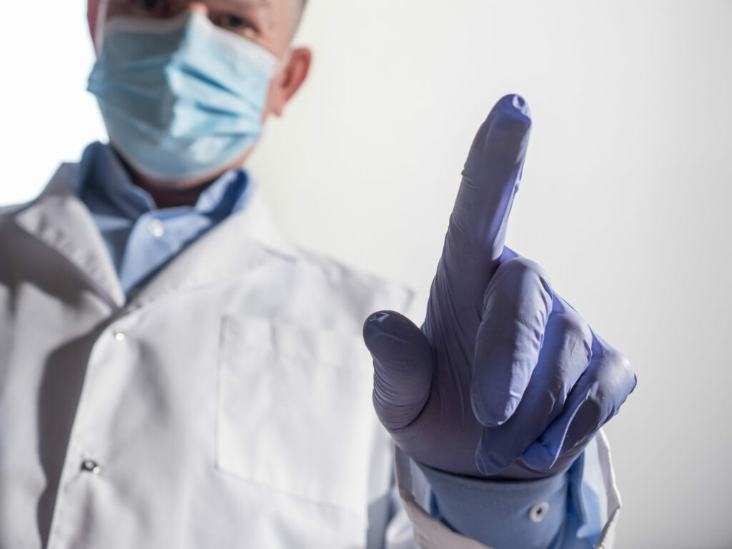 doctor wearing a rubber glove as a method of safety and infection control