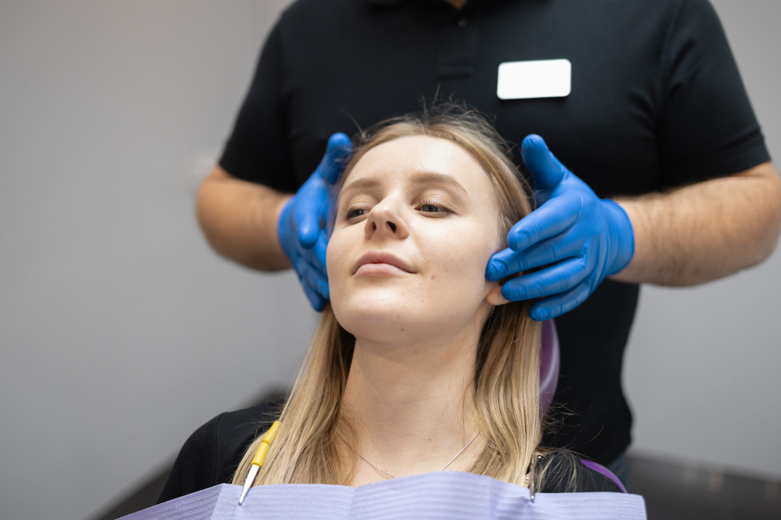 surgeon explaining to a patient what to expect following wisdom teeth extraction surgery at Associated Oral & Implant Surgeons